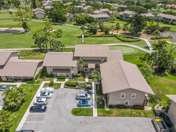 an aerial view of a house with a garden and lake view