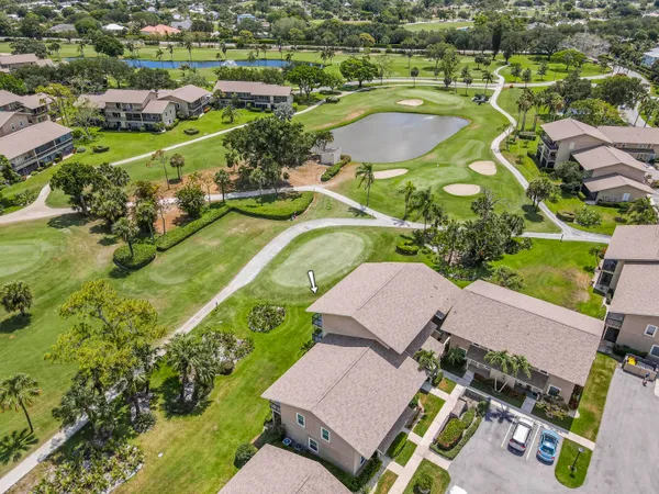 an aerial view of a house with a swimming pool yard and mountain view in back