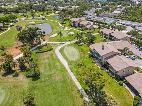 an aerial view of residential houses with outdoor space and swimming pool