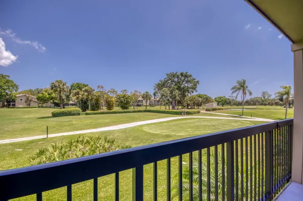a view of swimming pool from a balcony with outdoor space