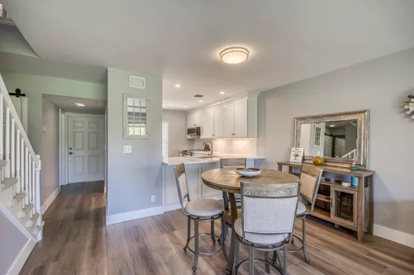 a view of a dining room with furniture and wooden floor