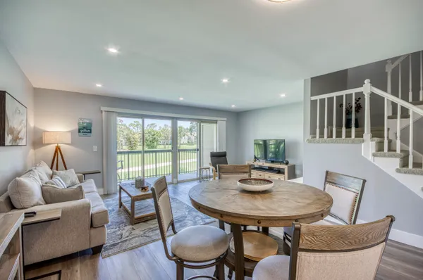 a view of a dining room with furniture window and wooden floor