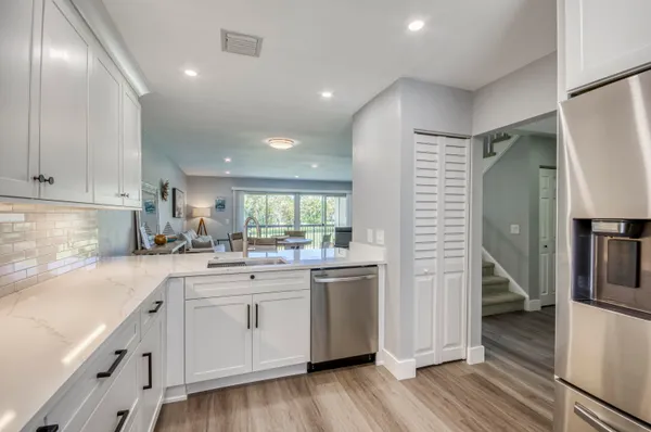 a kitchen with a sink stainless steel appliances and cabinets