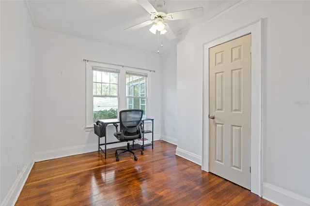 a view of a workspace with furniture and a window