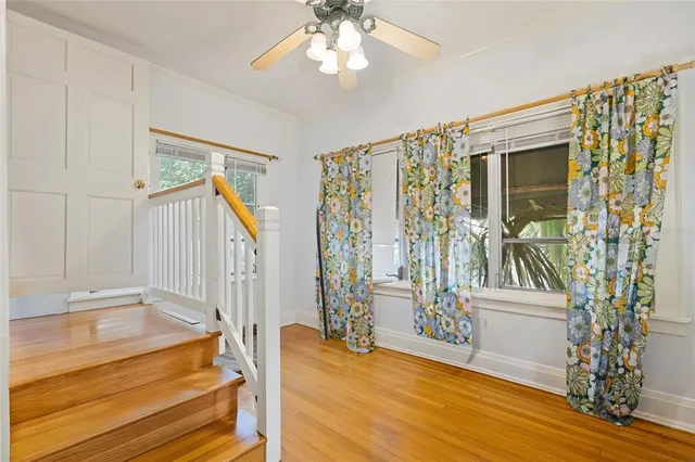 a view of an entryway with wooden floor and door