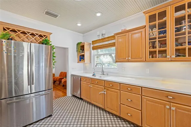 a kitchen with stainless steel appliances granite countertop a refrigerator and a sink