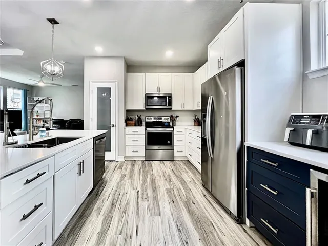 a kitchen with appliances cabinets and a counter top space
