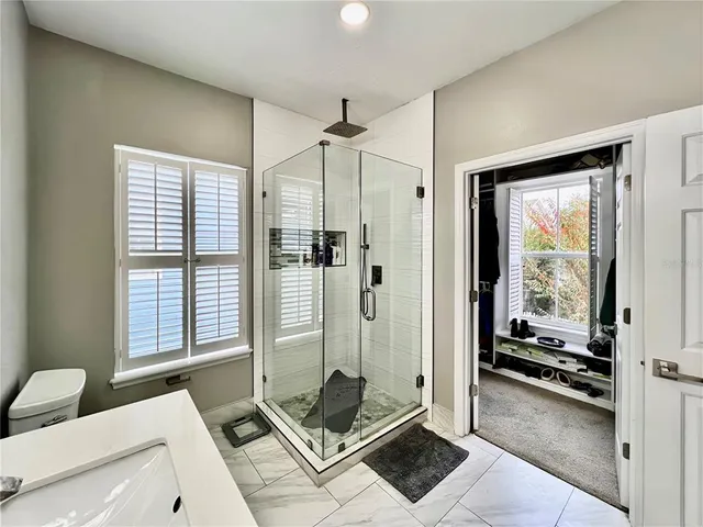 a view of walk in closet with clothes and shoes