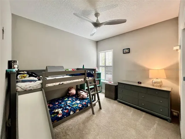 a view of road with card parked on side and retail shops