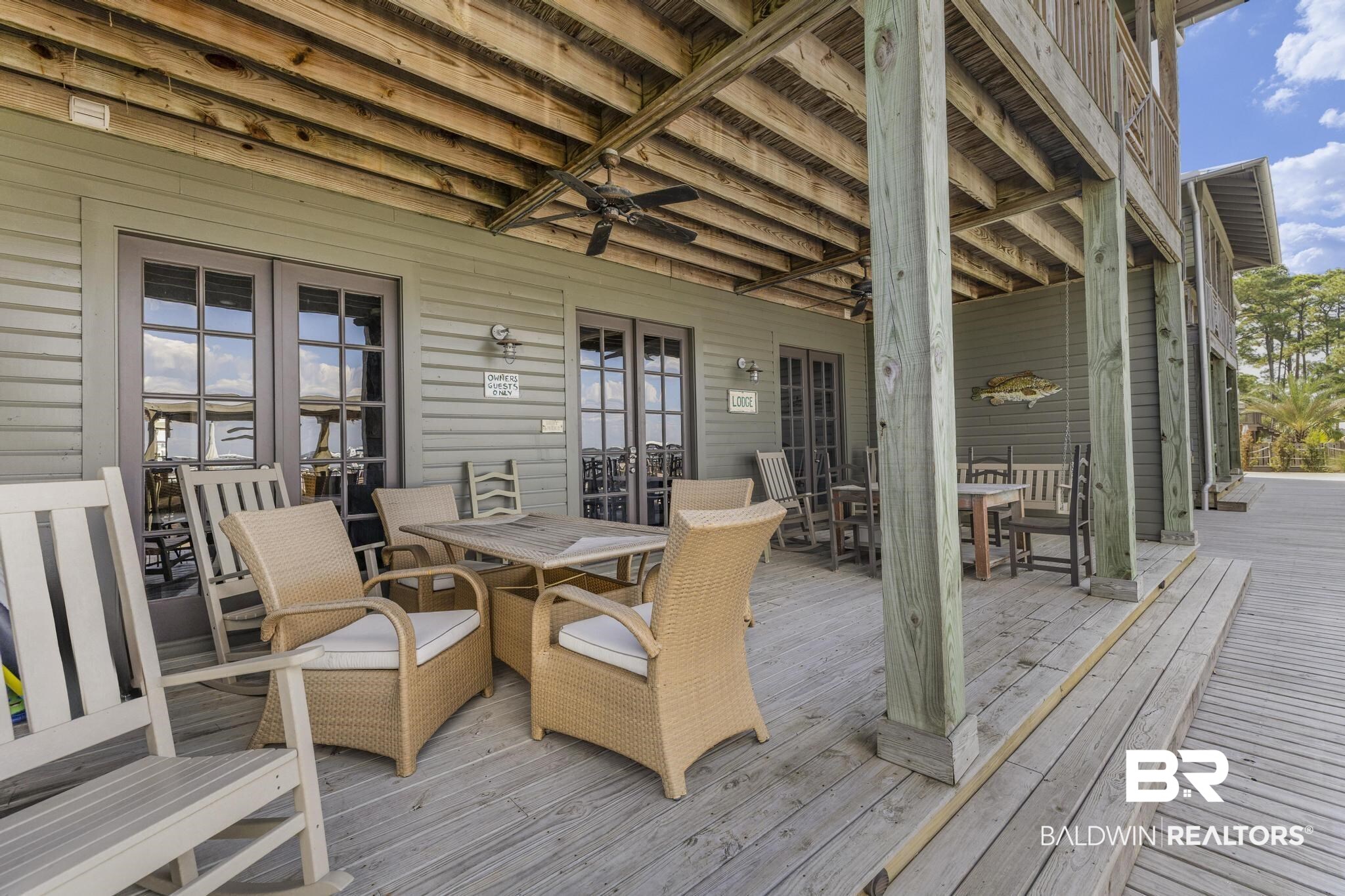 25773 Canal Road Orange Beach, AL 36561 - Photo 24 of 32 Deck with outdoor dining space, french doors, and a ceiling fan