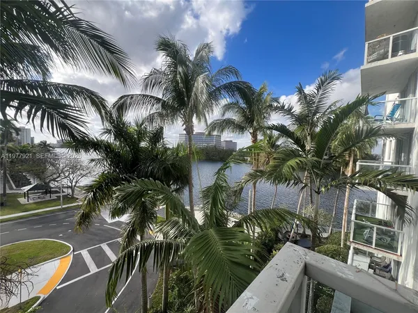 a view of balcony with furniture and palm trees