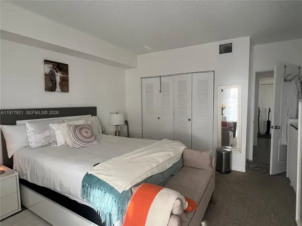 a bedroom with a bed and a lamp