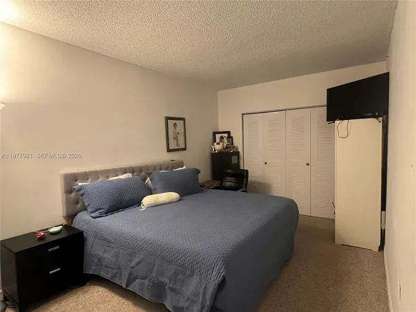 a bedroom with a bed and cabinets