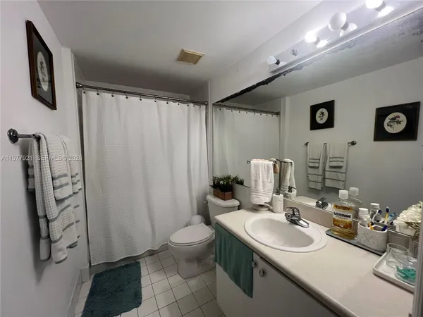 a bathroom with double vanity sink and two mirror