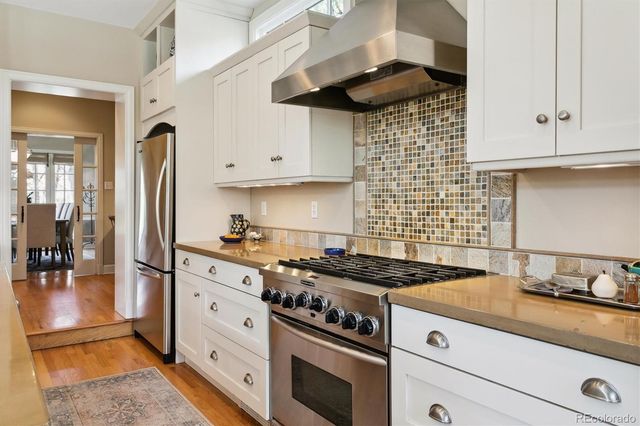 a kitchen with stainless steel appliances granite countertop a stove and a refrigerator