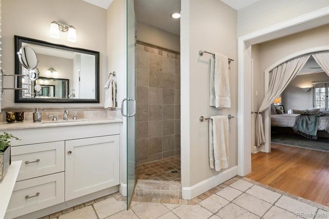 a en suite bathroom with a double vanity sink and a mirror