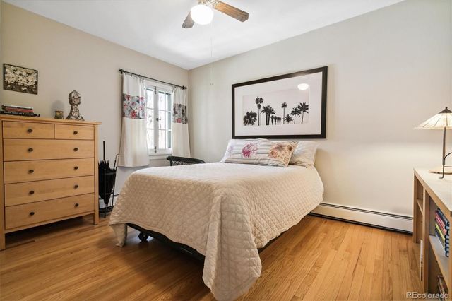 a bedroom with a bed and a painting on the wall