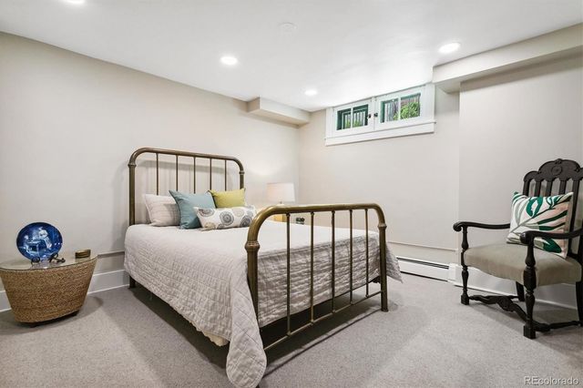 a spacious bedroom with a bed and a table