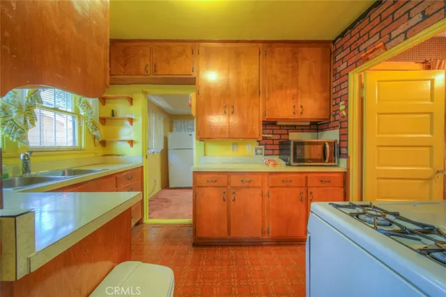 a kitchen with stainless steel appliances granite countertop a sink and a stove