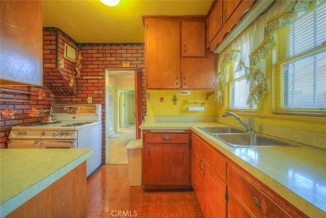 a utility room with a sink and cabinets