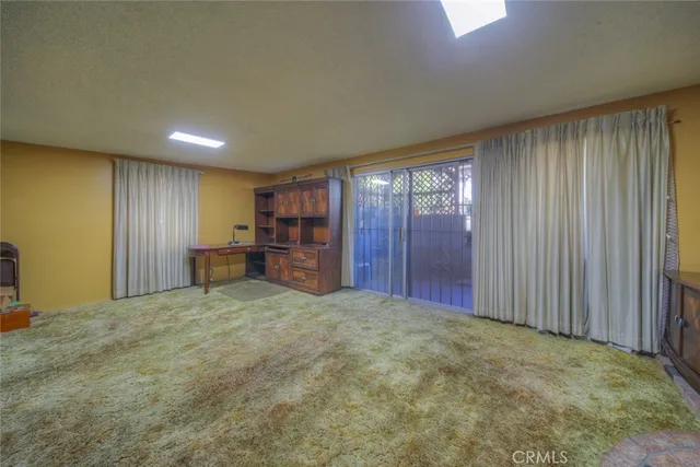 a view of house with outdoor seating and yard