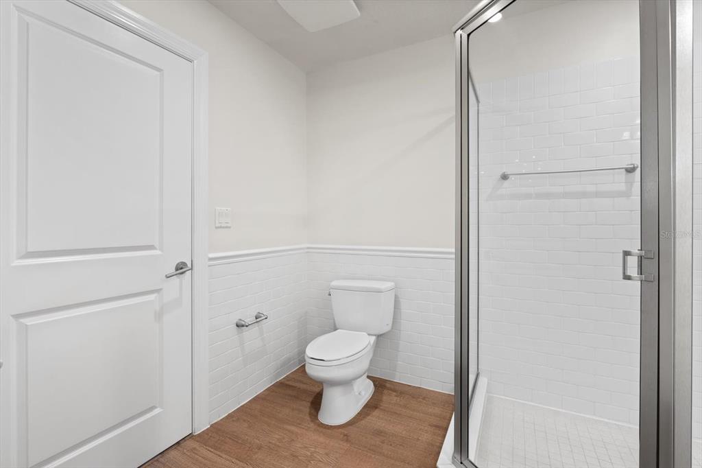536 Bahia Beach Boulevard, Unit 102A Ruskin, FL 33570 - Photo 11 of 28 a bathroom with a toilet and a shower