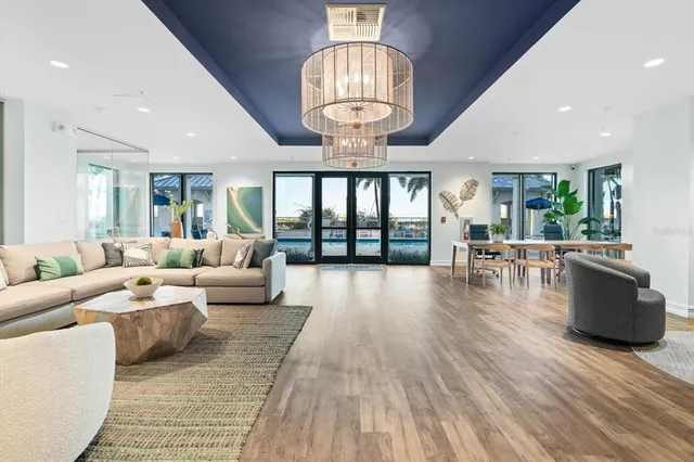 a living room with furniture and a chandelier