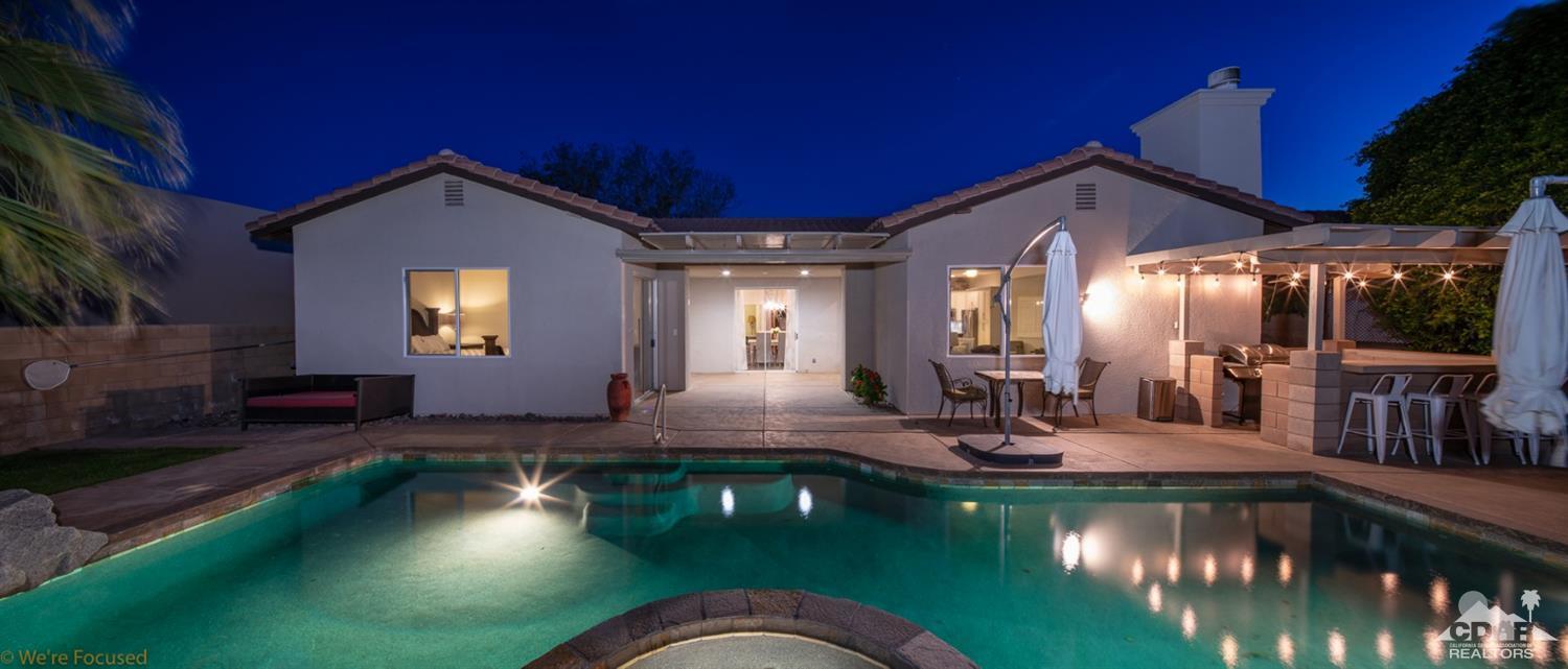 a view of a house with swimming pool and sitting area