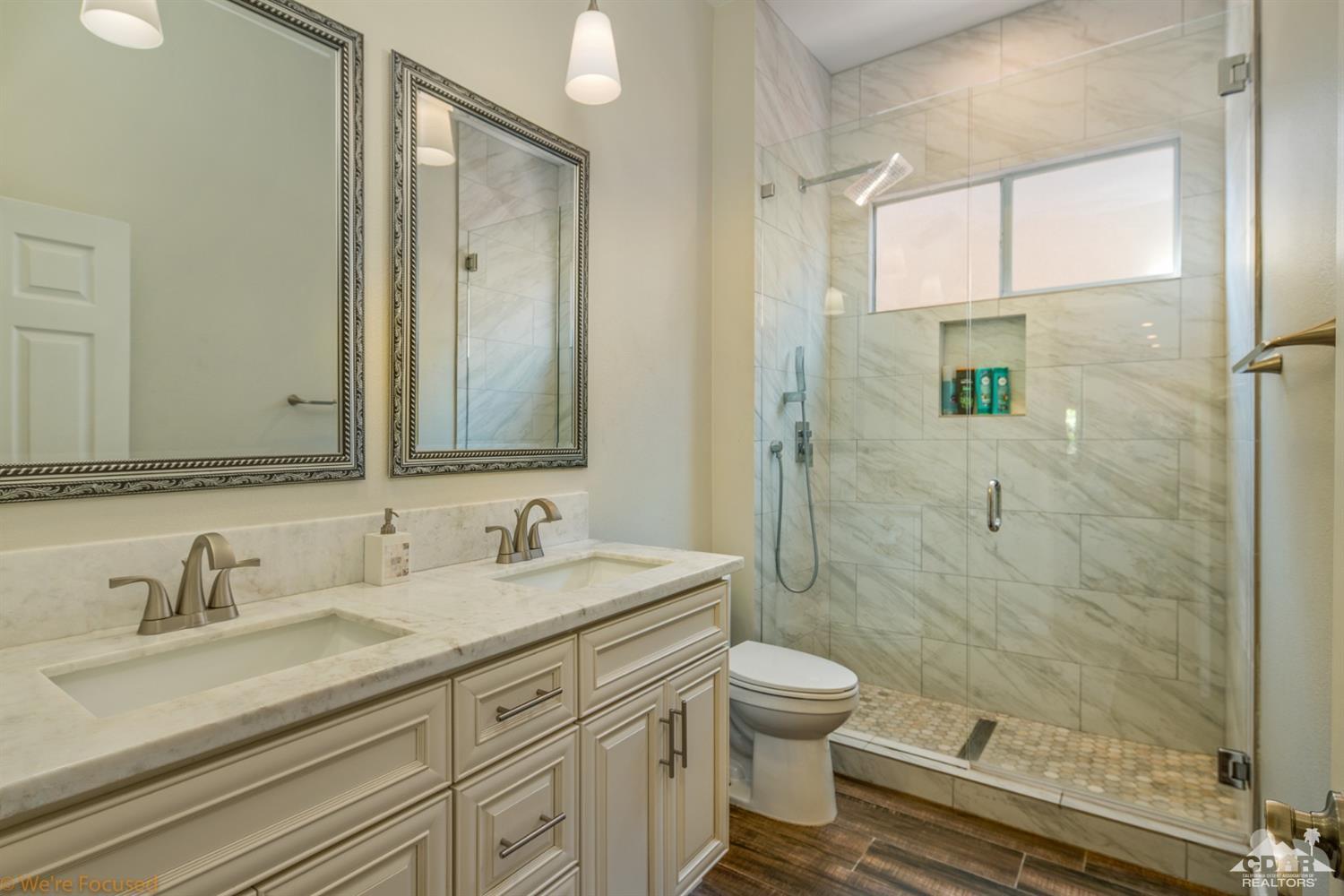 14 Tucson Circle Palm Desert, CA 92211 - Photo 11 of 20 a bathroom with a granite countertop sink toilet a mirror and shower