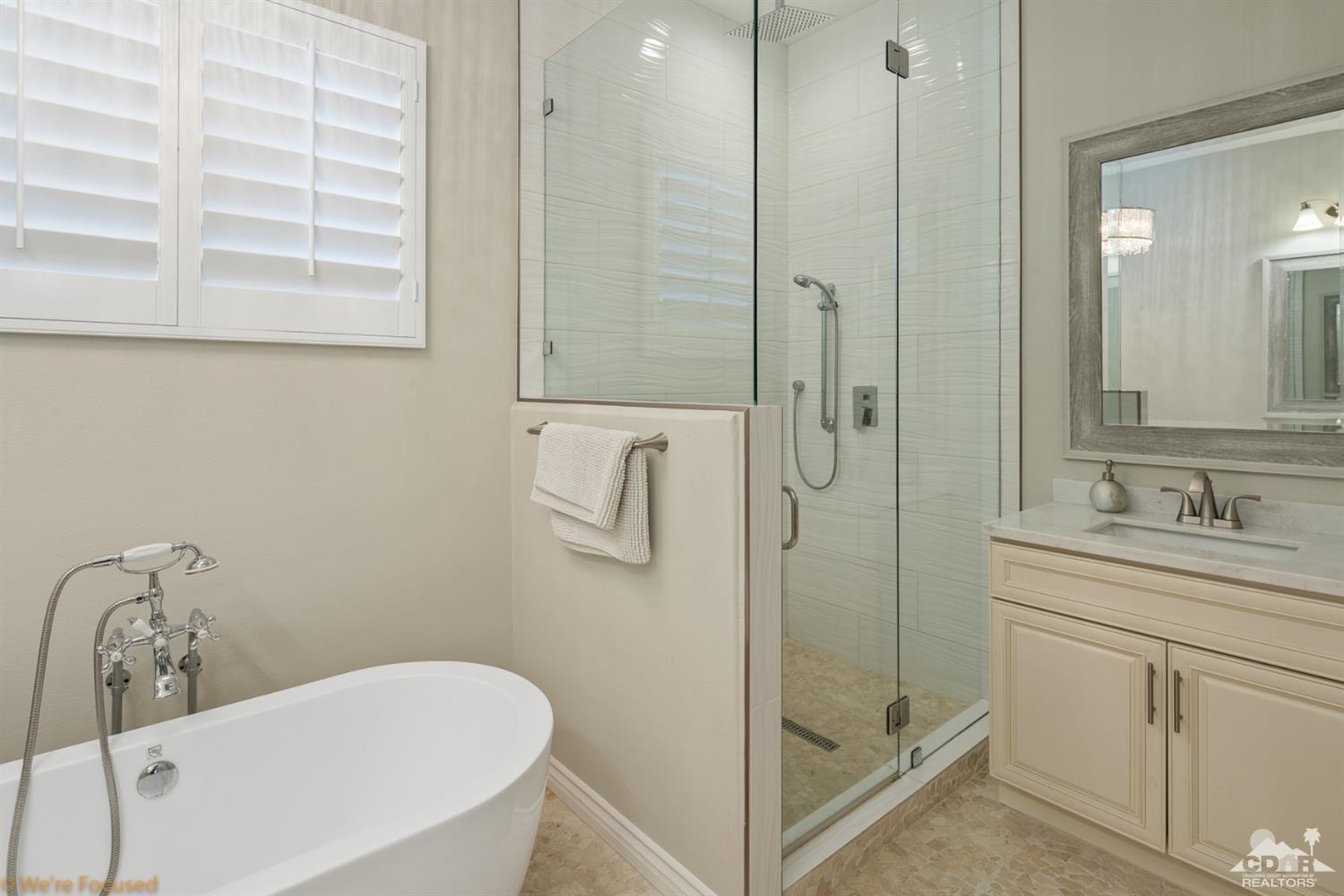 14 Tucson Circle Palm Desert, CA 92211 - Photo 17 of 20 a bathroom with a granite countertop sink mirror and a bathtub