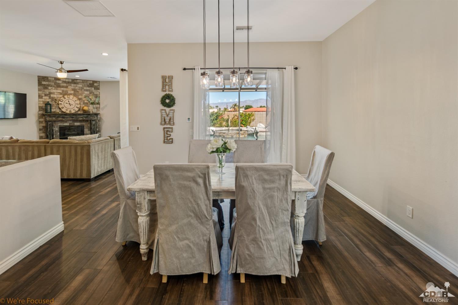 14 Tucson Circle Palm Desert, CA 92211 - Photo 10 of 20 a view of a dining room with furniture window and wooden floor