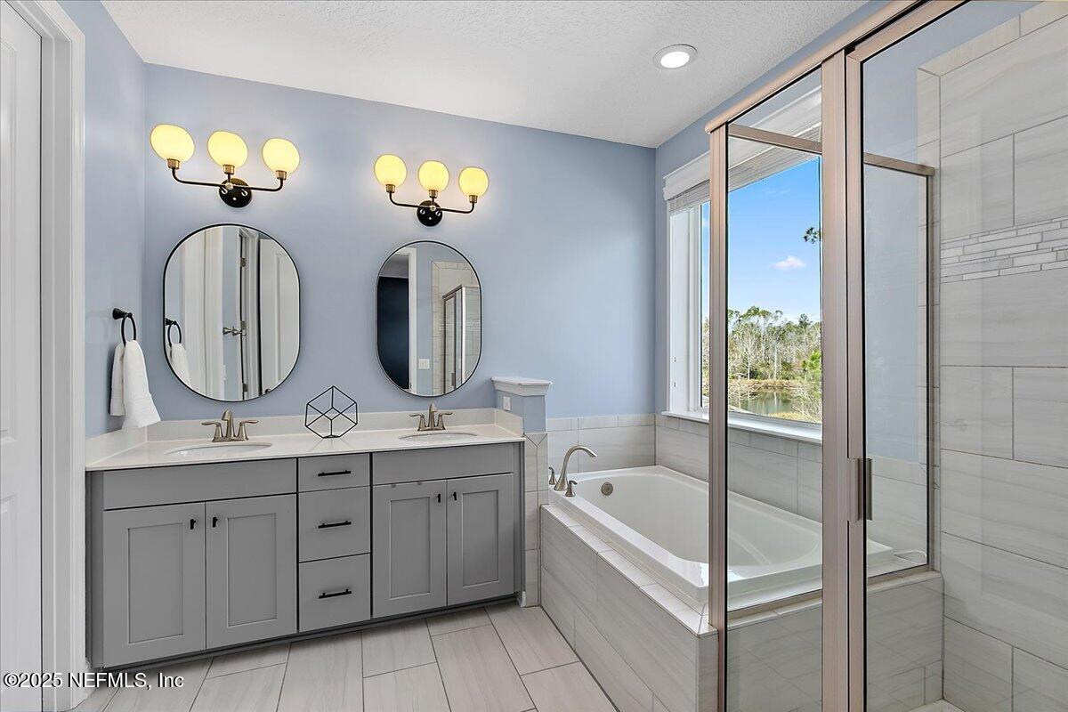78 Calumet Drive St. Johns, FL 32259 - Photo 22 of 72 a bathroom with a double vanity sink mirror and bathtub