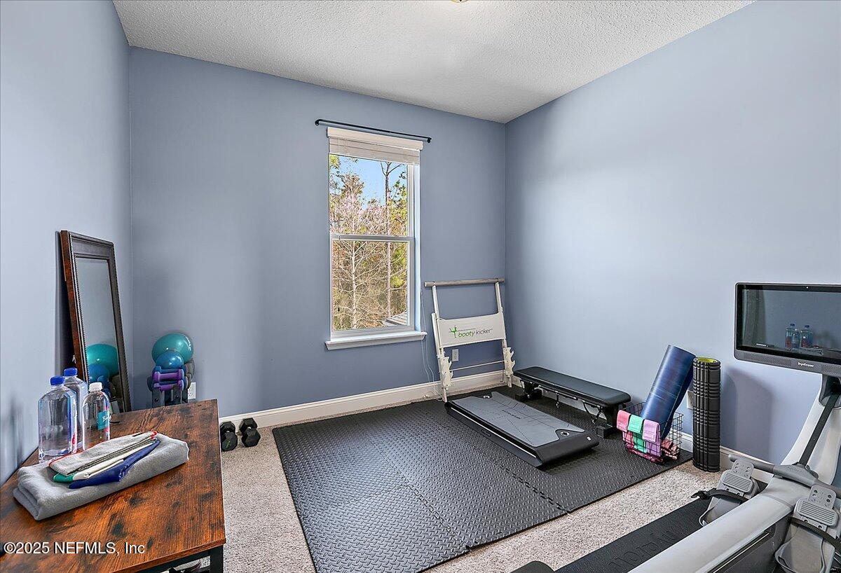 78 Calumet Drive St. Johns, FL 32259 - Photo 25 of 72 a living room with a bed furniture and a window