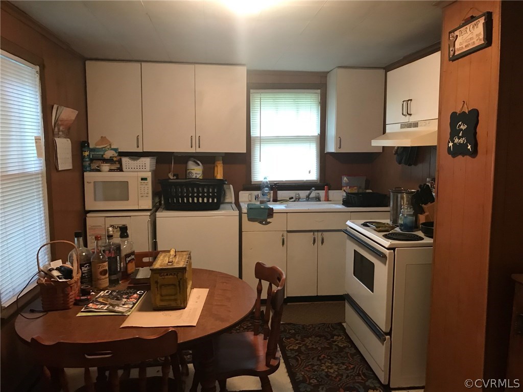 606 Cedar Level Road Hopewell, VA 23860 - Photo 3 of 7 a kitchen with a dining table and chairs