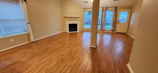 wooden floor in an empty room with a fireplace