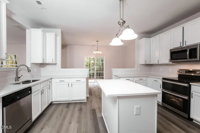 a kitchen with a sink stove and cabinets