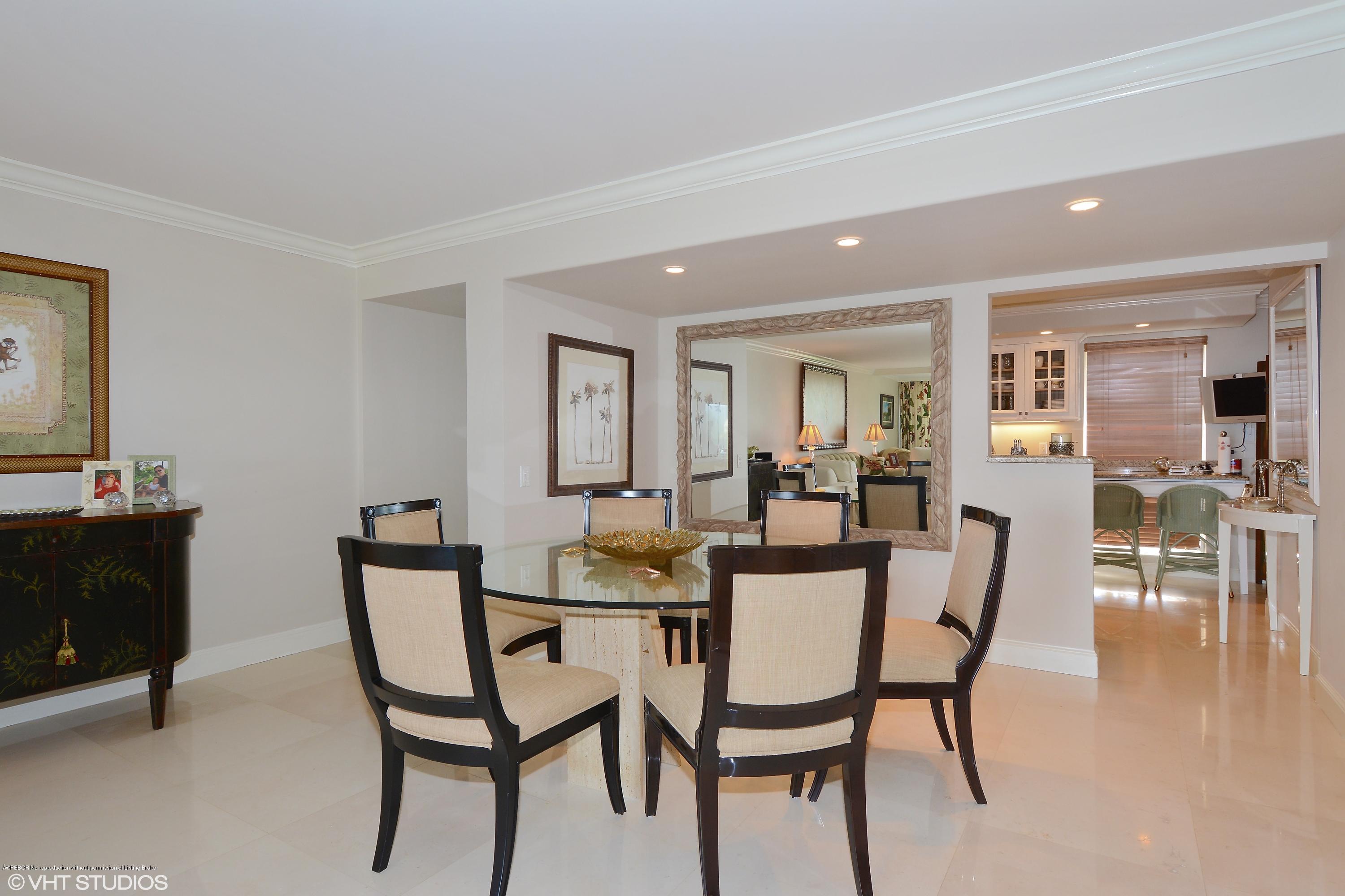 2190 Ibis Isle Road, Unit 1 Palm Beach, FL 33480 - Photo 2 of 8 a dining room with furniture and wooden floor