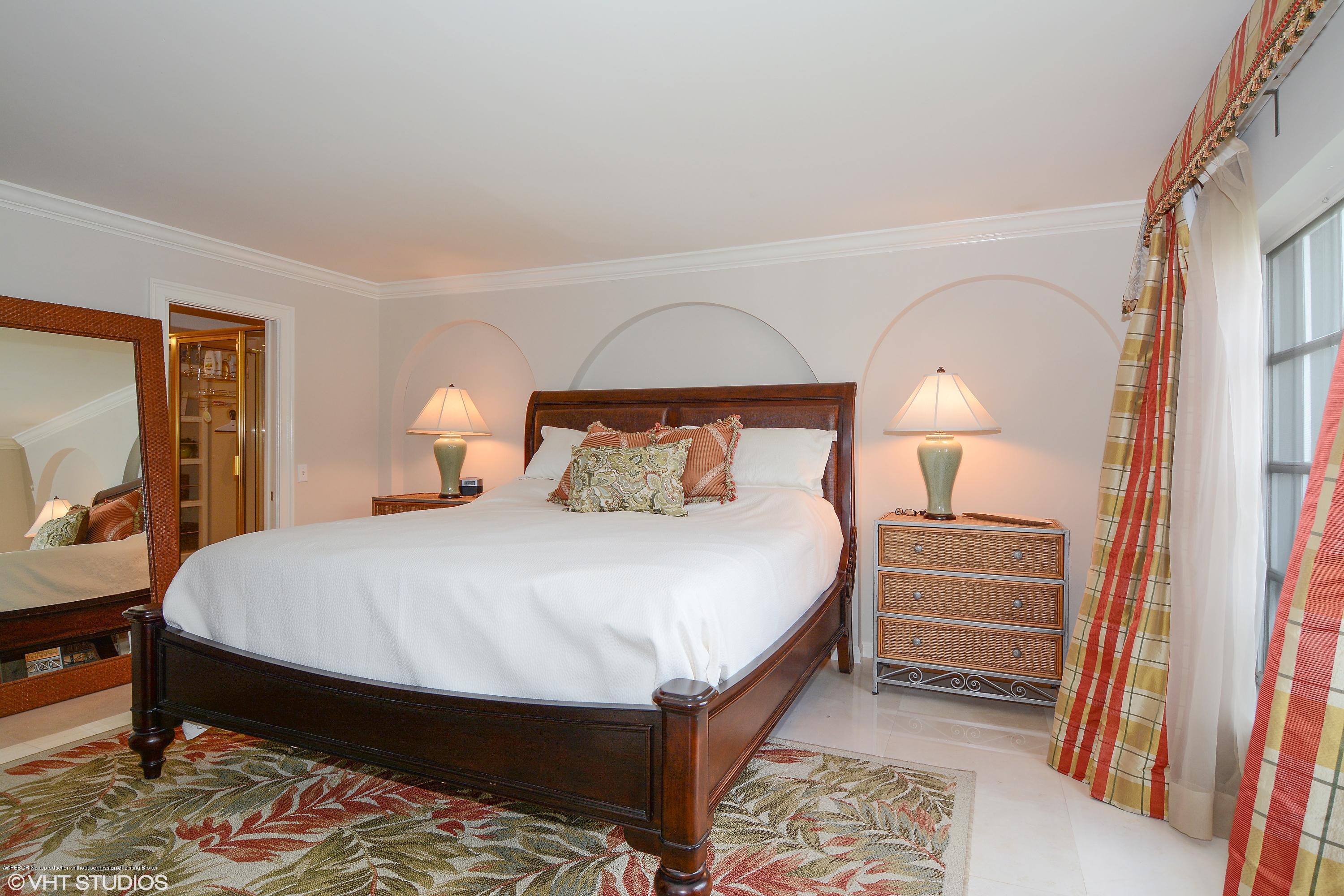 2190 Ibis Isle Road, Unit 1 Palm Beach, FL 33480 - Photo 4 of 8 a bedroom with a bed and a mirror