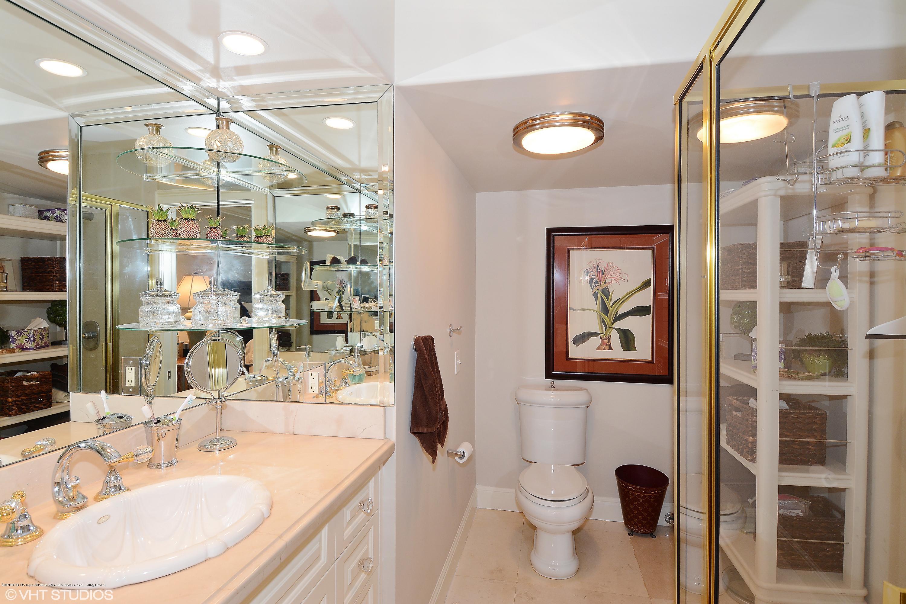 2190 Ibis Isle Road, Unit 1 Palm Beach, FL 33480 - Photo 5 of 8 a bathroom with a sink a toilet and shower
