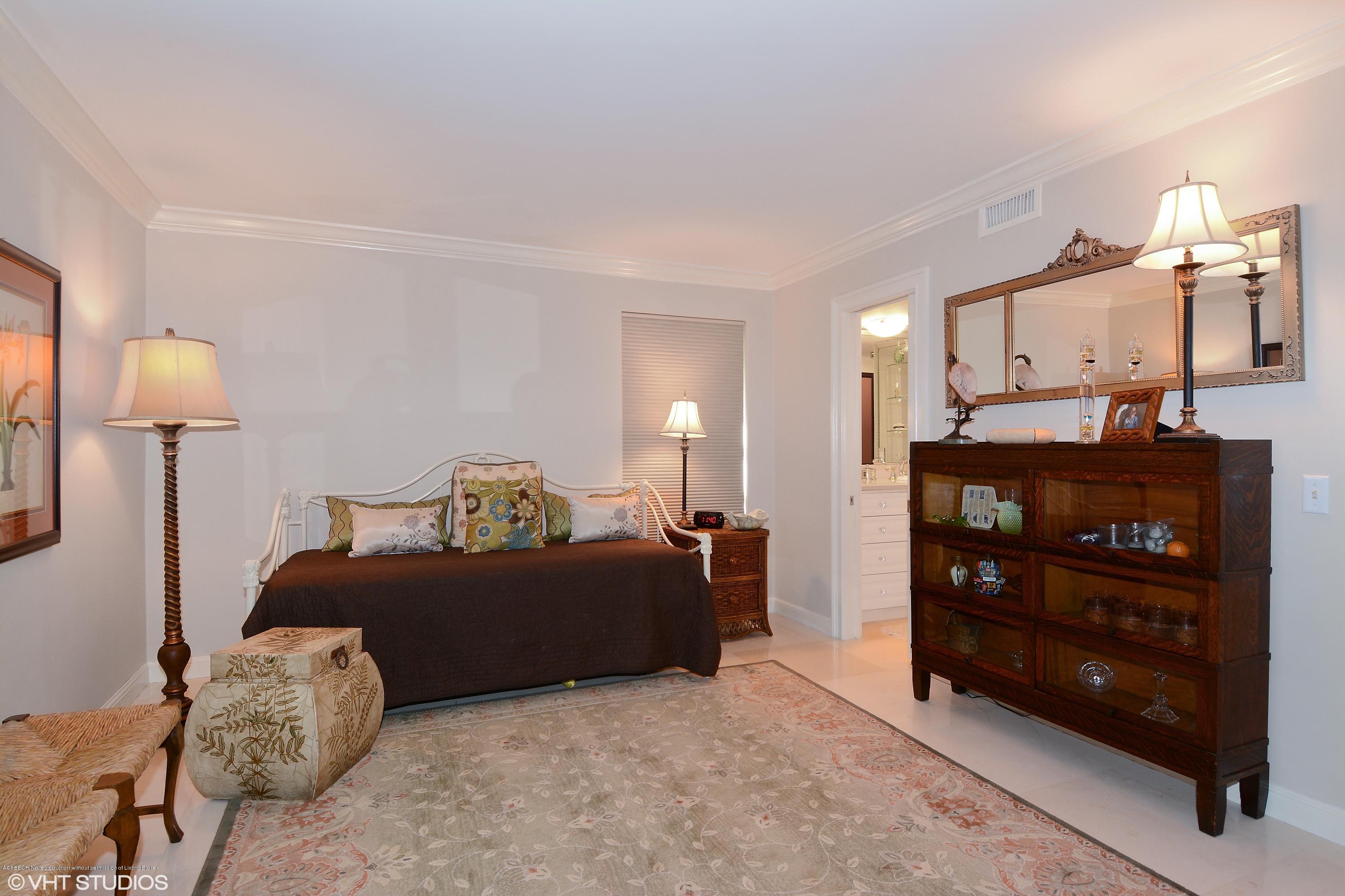 2190 Ibis Isle Road, Unit 1 Palm Beach, FL 33480 - Photo 6 of 8 a bedroom with a bed and a lamp