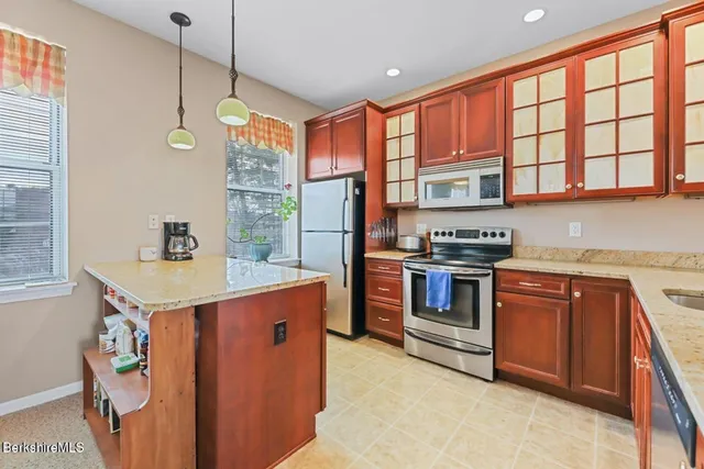 a kitchen with stainless steel appliances granite countertop a stove and a sink