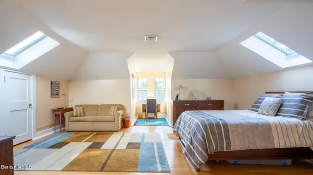 a bedroom with two beds and a couch