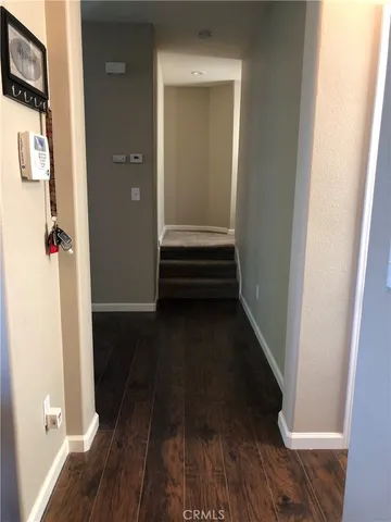 a living room with furniture wooden floor and a large window