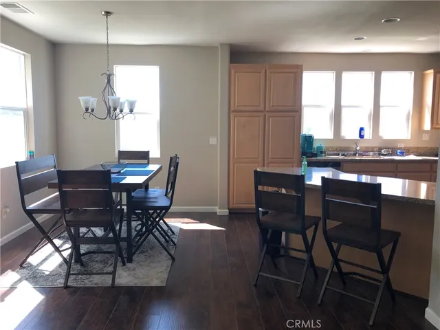 a kitchen with kitchen island granite countertop a stove sink and refrigerator