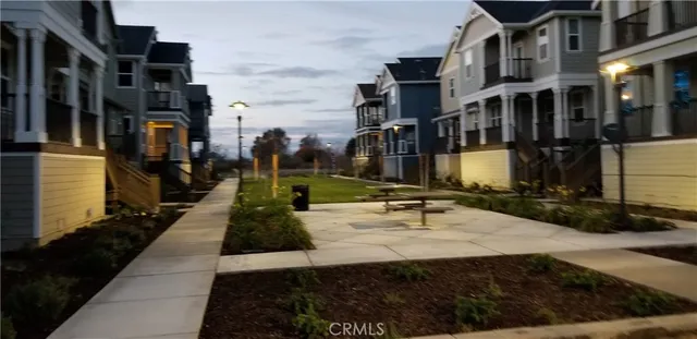 a view of staircase with railing and white walls