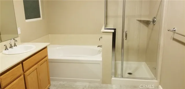 a bed sitting in a bedroom next to a lamp