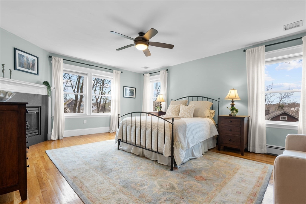 57 Edmund Road Arlington, MA 02474 - Photo 16 of 36 a spacious bedroom with a bed and a couch