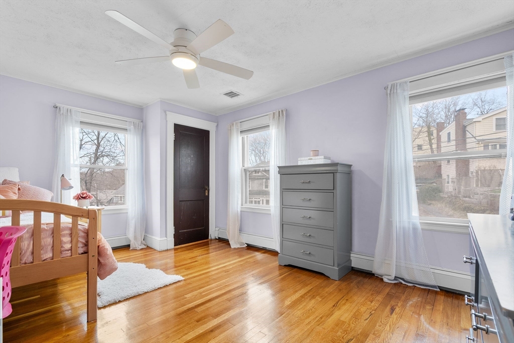 57 Edmund Road Arlington, MA 02474 - Photo 22 of 36 a view of an empty room with a window and wooden floor