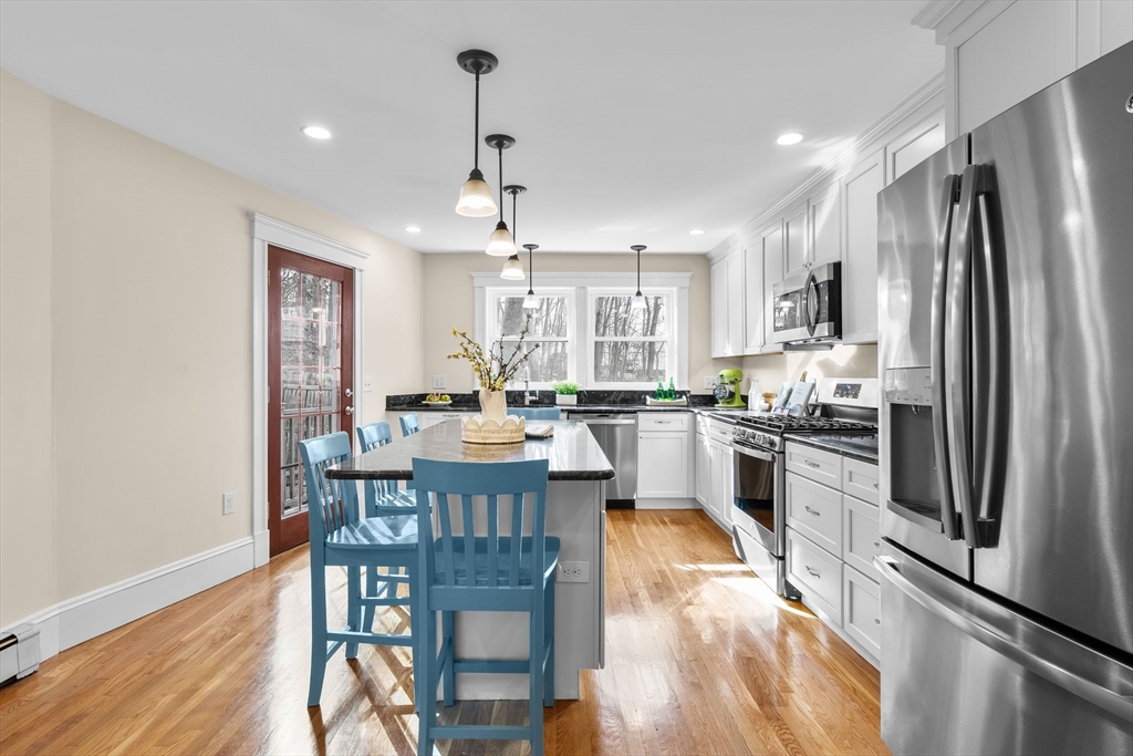 57 Edmund Road Arlington, MA 02474 - Photo 3 of 36 a kitchen with refrigerator a sink and chairs