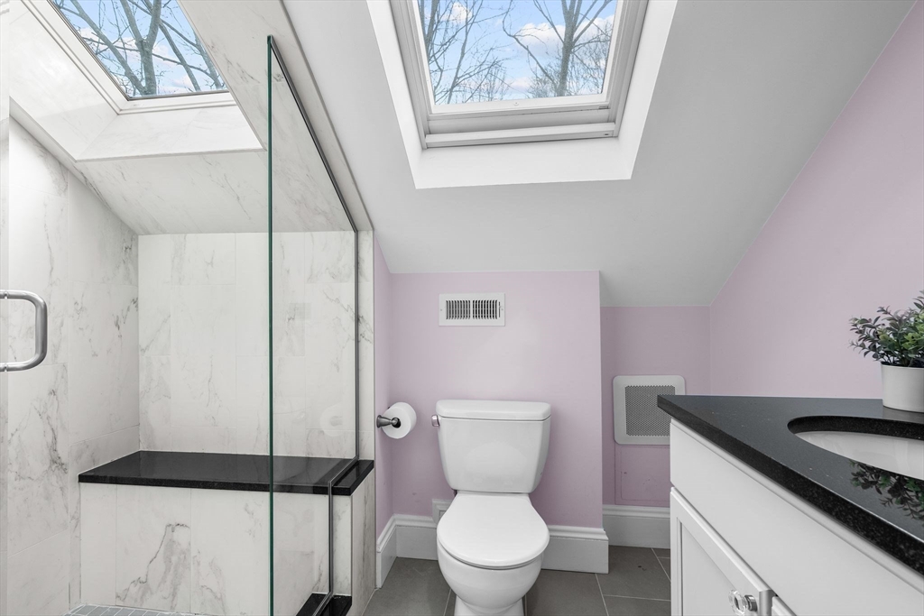 57 Edmund Road Arlington, MA 02474 - Photo 31 of 36 a white toilet sitting next to a bathroom sink